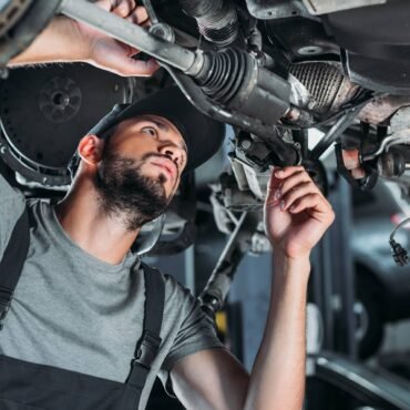 mechanic-in-overalls-repairing-car-in-auto-repair-2022-12-16-18-39-34-utc.jpg