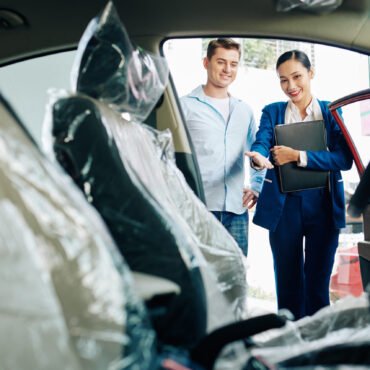 Manager showing car interior